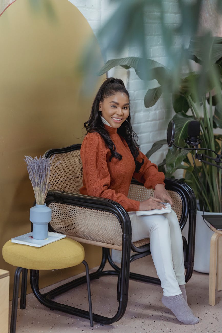 cheerful black woman near microphone in room