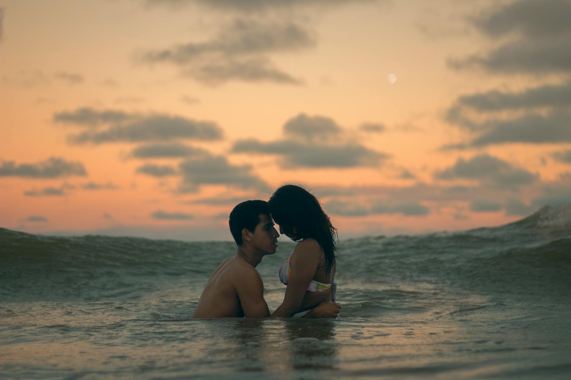 man and woman in the middle of ocean