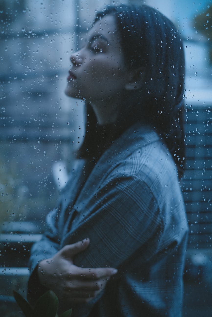 unhappy thoughtful teen girl arms crossed in rainy day