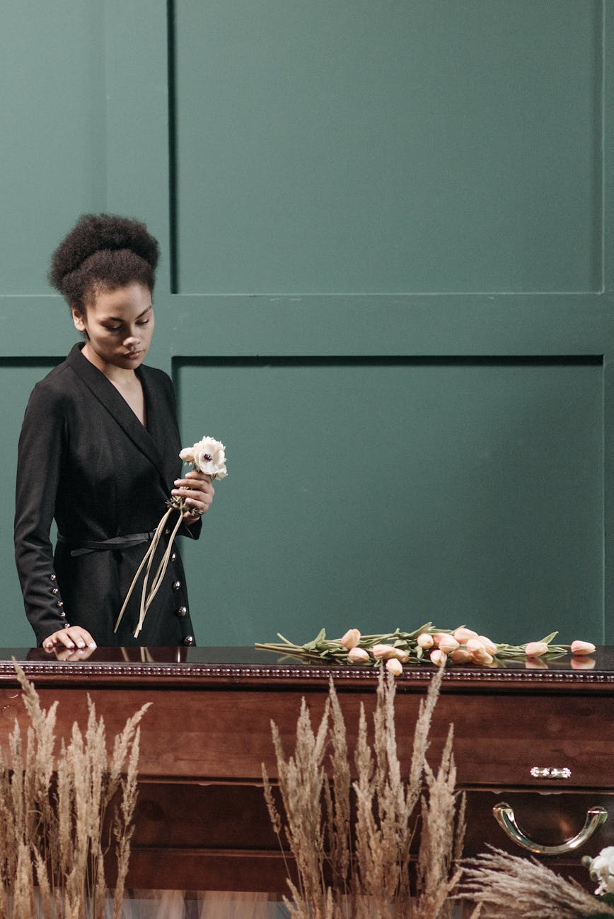 a woman standing near the coffin