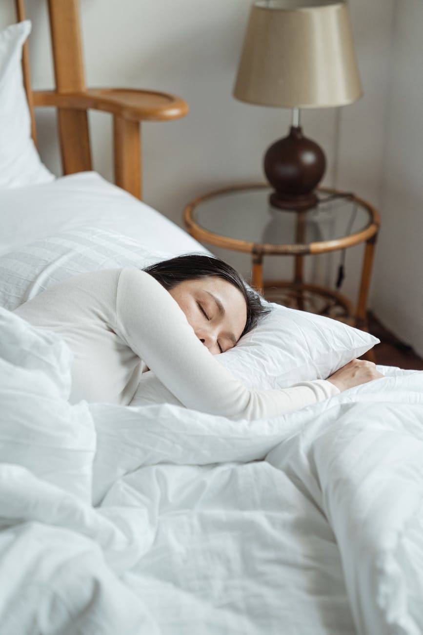 young woman sleeping in comfy bed