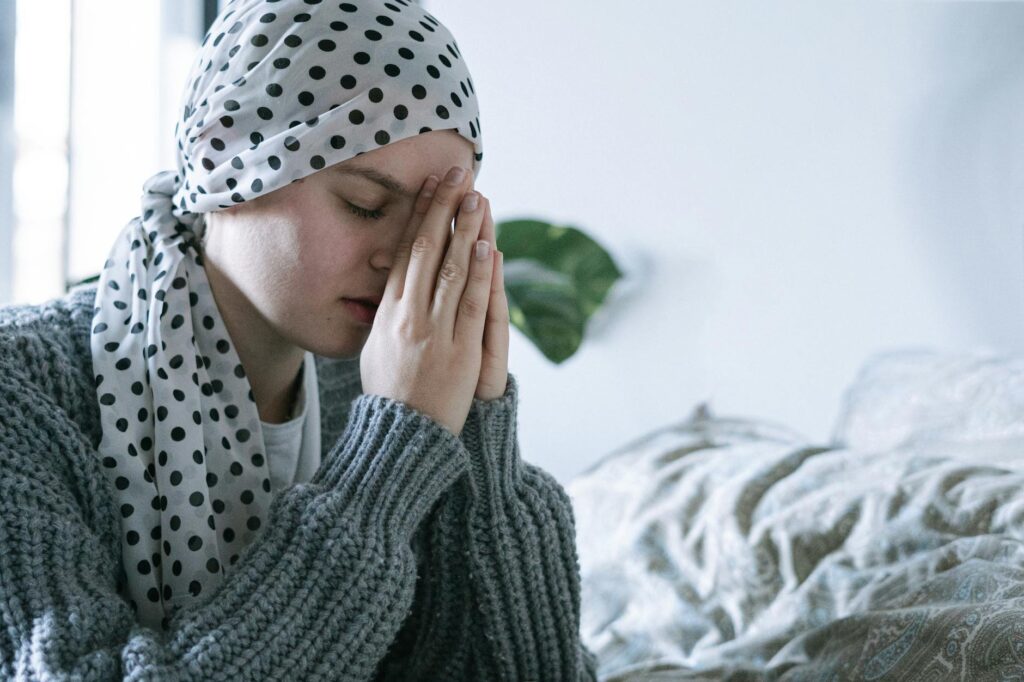 woman in gray knit sweater praying