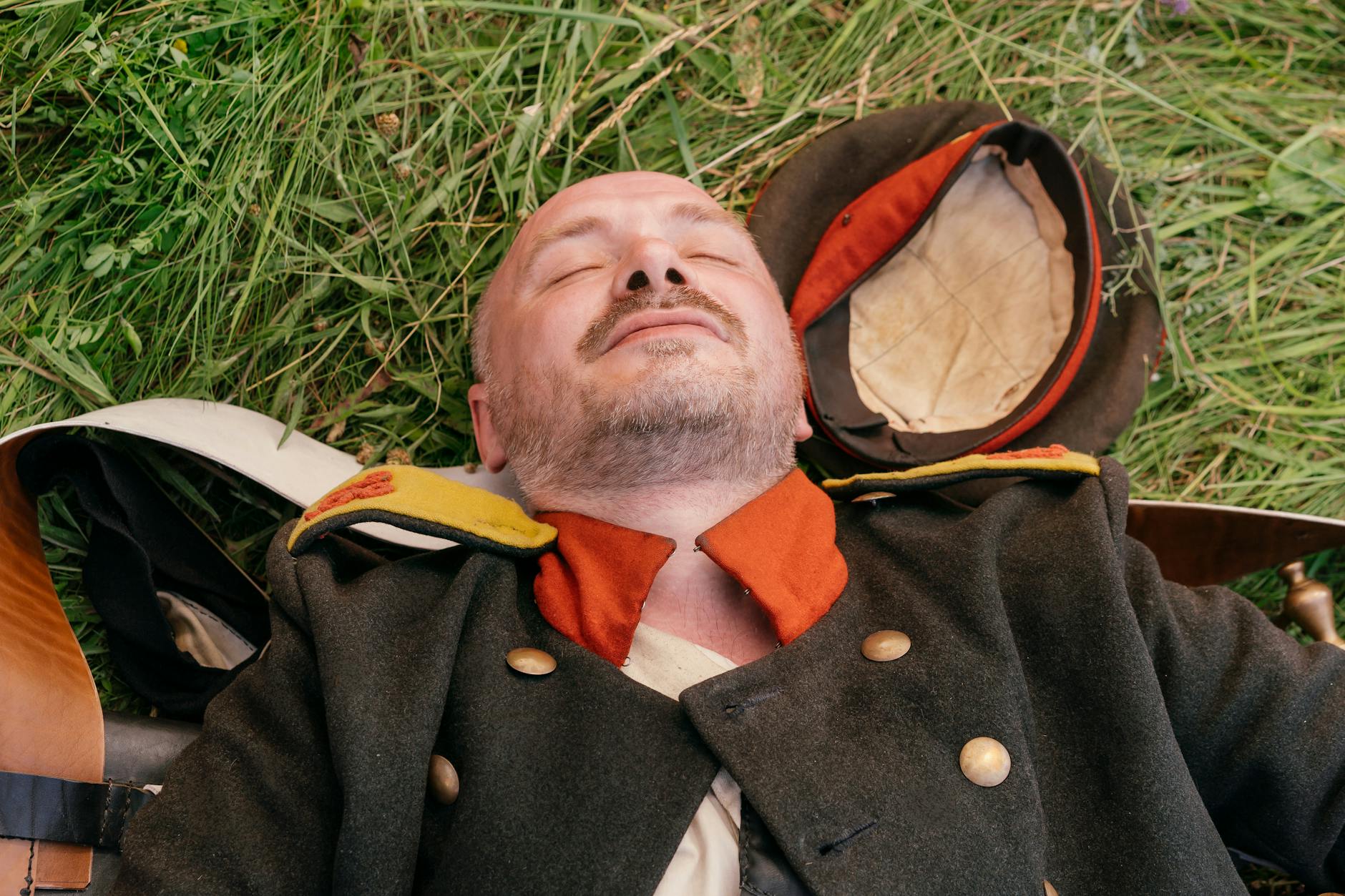 man sleeping on green grass