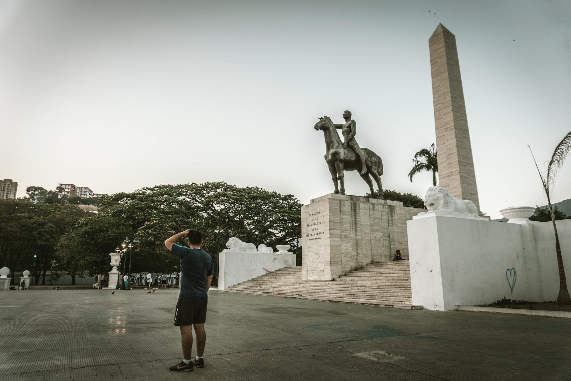 a man standing near the statue