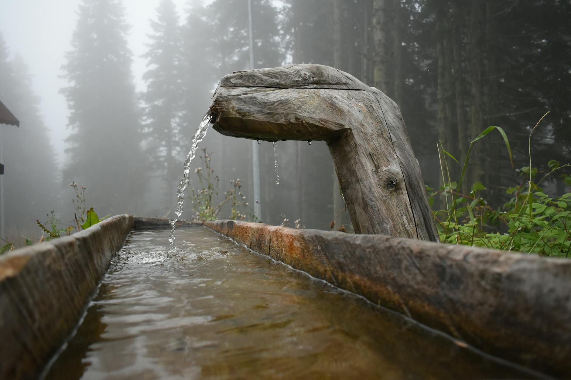 water falling into a wooden gutter