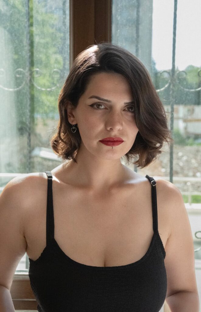 a woman with short hair and a black top